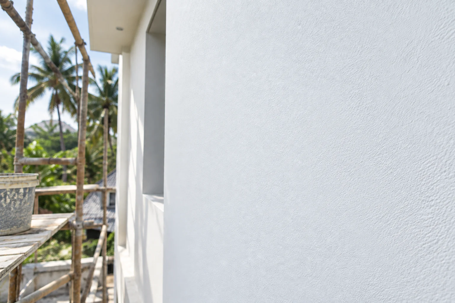 Extra opacity &mdash; the primed side burying patchy plaster the untreated side still shows