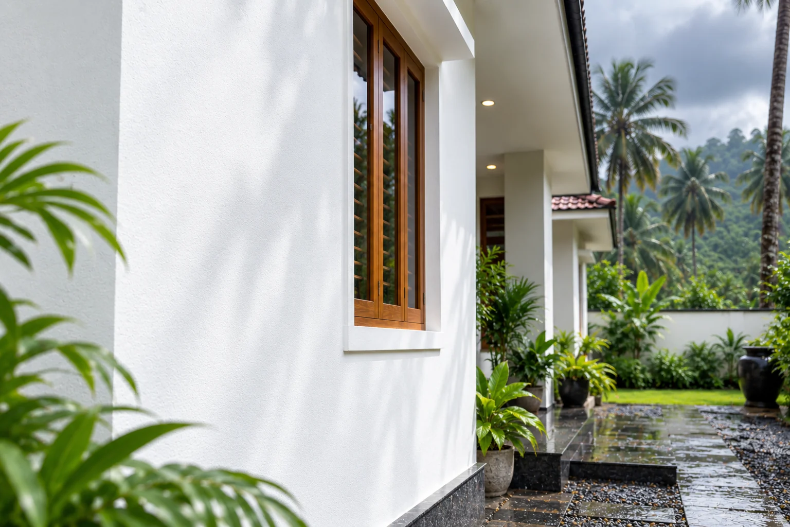 Extra whiteness &mdash; a bright white elevation against monsoon greenery and hills